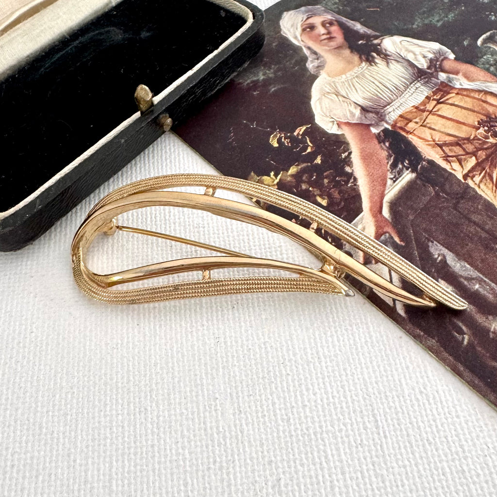 Vintage Sarah Coventry signed "stunning" gold tone brooch on an old jewellery box and with a vintage postcard