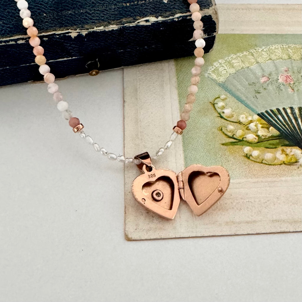 Necklace with heart-shaped locket on a textured surface