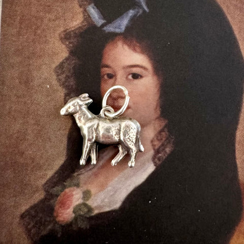 Vintage silver goat charm on an Old masters portrait of a Spanish woman
