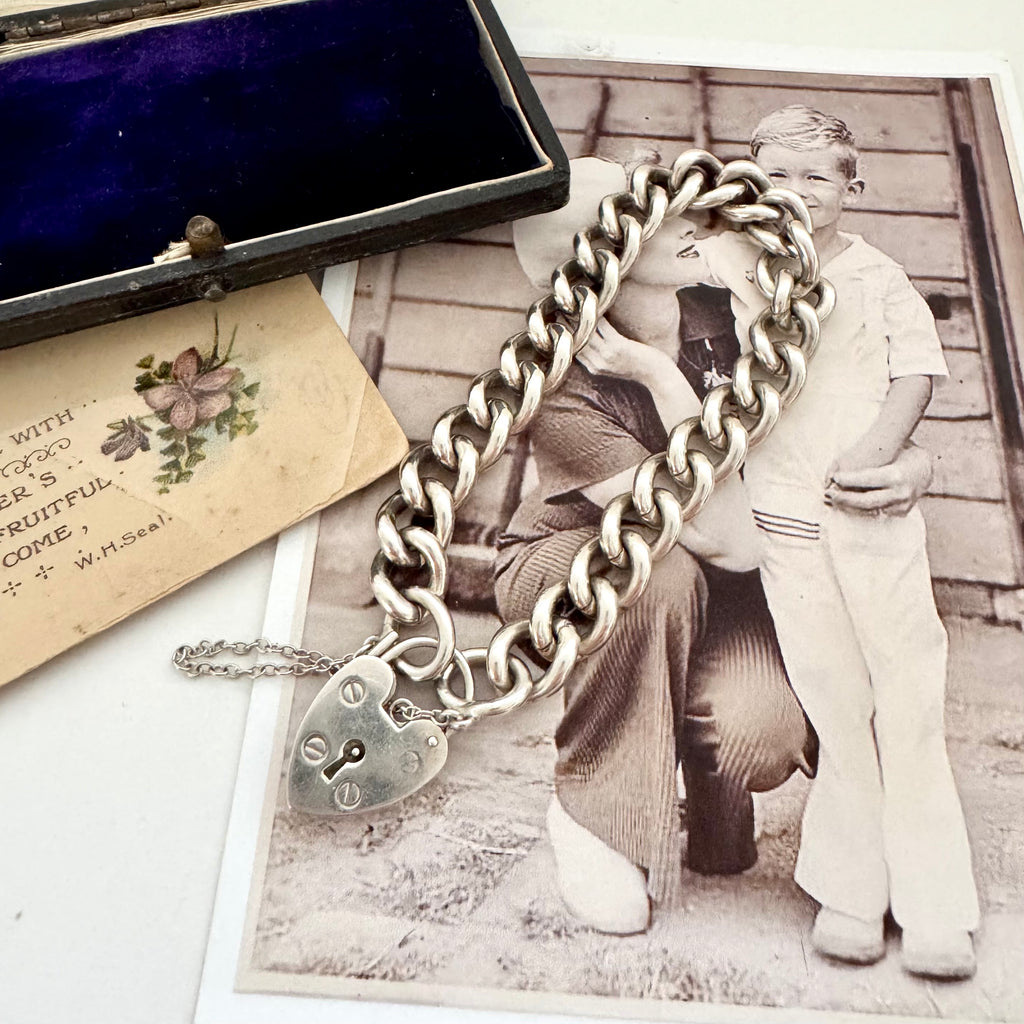Vonk Jewellery heavy sterling silver curb link chain bracelet with heart padlock clasp on vintage postcards and with a vintage jewellery box
