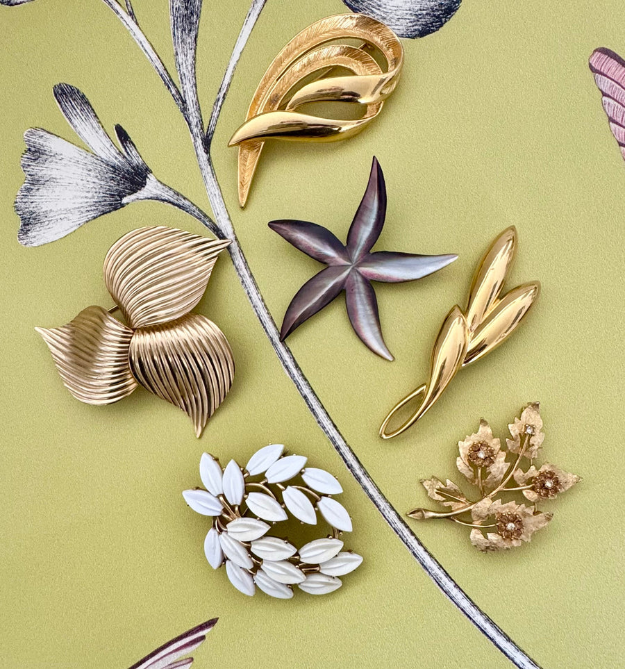 Vintage brooches on a green background