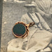9ct  rose gold antique swivel fob with a dark stone on an antique photo of an old woman