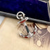 Antique sterling silver and agate anchor brooch on an antique photo