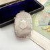 Antique 1879 Victorian silver vesta case on a white background with a vintage postcard and old box in the background.