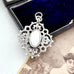 Decorative silver antique watch fob pendant on a vintage photograph