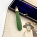 Antique 9ct rose gold and greenstone pendant  on a vintage photograph