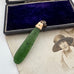 Antique 9ct rose gold and greenstone pendant  on a vintage photograph