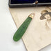 Antique 9ct rose gold and greenstone pendant  on a vintage photograph