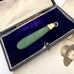 Antique 9ct rose gold and greenstone pendant  in an open vintage jewellery box