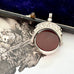 Antique 1896 Chester hallmarked carnelian and bloodstone spinning fob on a jewellery box.