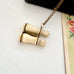 Antique Edwardian stanhope Lourdes binoculars necklace on a chain with a black case and floral illustration in the background.