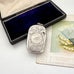 Antique sterling silver 1887 vesta case with intricate patterns on a white surface next to an open jewelry box and vintage card.