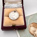 Antique silver British sixpence with 'Albert' engraved in a decorative box on an image of an angel.