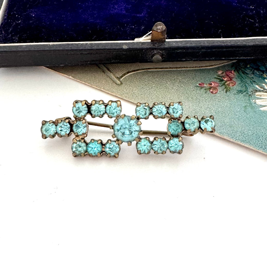 Art Deco era blue paste brooch  on a white surface