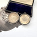 Silver locket with open face on a white background
