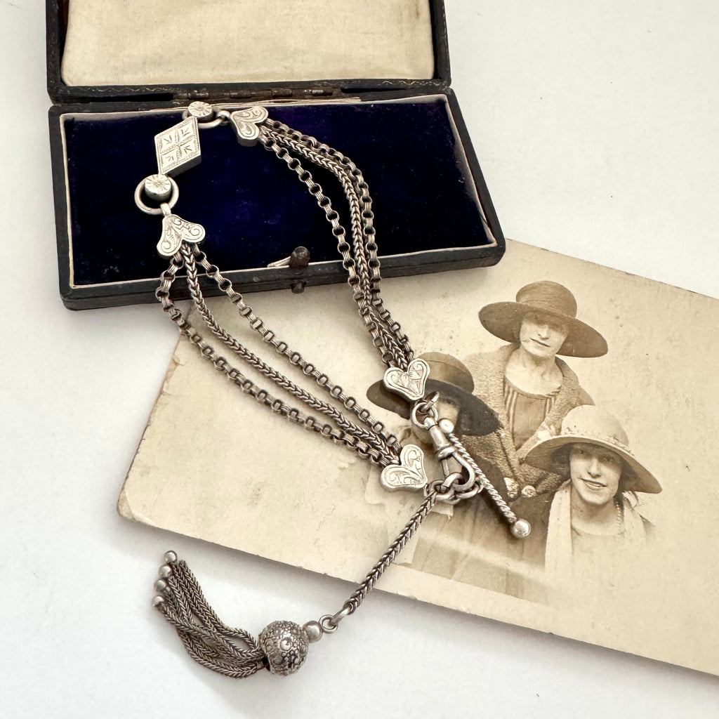 Antique Victorian continental silver triple strand Albertina watch chain with tassel on an old photograph