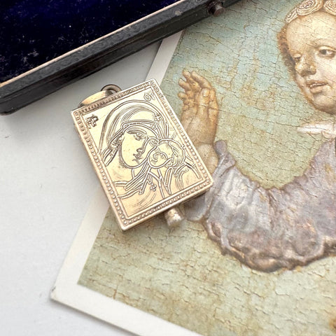 Antique early vintage silver reliquary locket or pendant with an engraving of Byzantine Madonna and Child on a picture of an angel