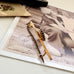 Vonk jewellery red paste stone 9ct gold bar brooch on a vintage photo and postcard