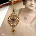 Antique Edwardian art nouveau lavalier pendant necklace with a central purple gemstone and a dangling flower-shaped purple gemstone, displayed over an old sepia-toned portrait photograph.