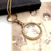 Antique gold magnifying glass necklace  on an old photograph