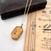Antique pinchbeck vinaigrette on a chain with an old document in the background
