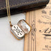 Open antique pinchbeck vinaigrette on a chain with an old document in the background