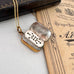 Open antique pinchbeck vinaigrette on a chain with an old document in the background