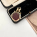 Antique carnelian and bloodstone rolled gold spinning fob on an old jewellery box