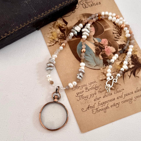 Antique photo locket and crystal and pearl necklace  on a vintage card