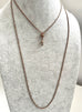 Antique A.H.B & C rolled rose gold guard chain with opal slider on agrey mannequin
