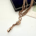 Antique A.H.B & C rolled rose gold guard chain with opal slider on an old postcard.