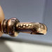 Close-up of A.H.B & Co clip on an antique guard chain on a neutral background