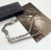 Antique albertina chain on a white background and with an old postcard and box