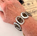 Bracelet made from antique silver buckles on a womans wrist