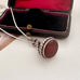 Antique silver and carnelian watch fob on a white background and with an old jewellery box