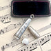 Antique silver cheroot holder case on old sheet music and with a jewellery box