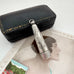 Antique silver cheroot holder case on an old postcard of a woman.