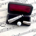 Antique silver cheroot holder case on an old jewellery box and old sheet music