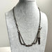 Antique Victorian continental silver triple strand Albertina watch chain with tassel on a grey mannequin