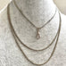 Antique silver guard chain necklace on a grey mannequin