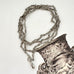 Antique silver fancy link guard chain with an engraved picture or an urn in the corner