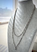 Antique silver fancy link guard chain on a grey mannequin