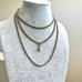 Antique silver plated guard chain on a pale grey mannequin