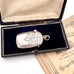 Silver antique vesta case pendant in an open box with an old document underneath