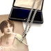 Antique silver watch chain necklace on an old jewellery box and with an old postcard