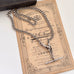 Antique silver watch chain necklace on an antique advertising card and a vintage jewellery box