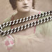 Large silver chain over an old photograph of a woman