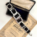 Antique sterling silver buckle bracelet on a   vintage box on an old paper background