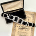 Antique sterling silver buckle bracelet on a   vintage box on an old paper background