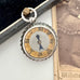 Antique silver compass watch fob  on an old photograph
